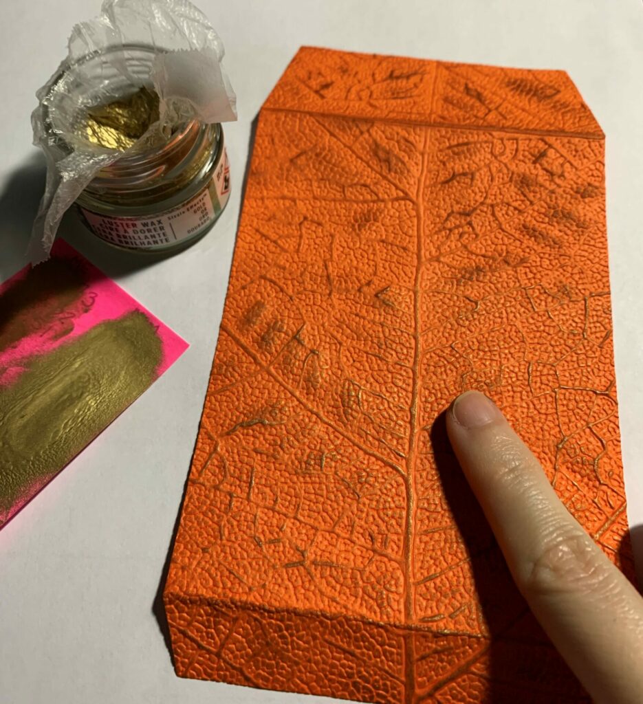 Applying the luster wax to the leaf embossed envelope