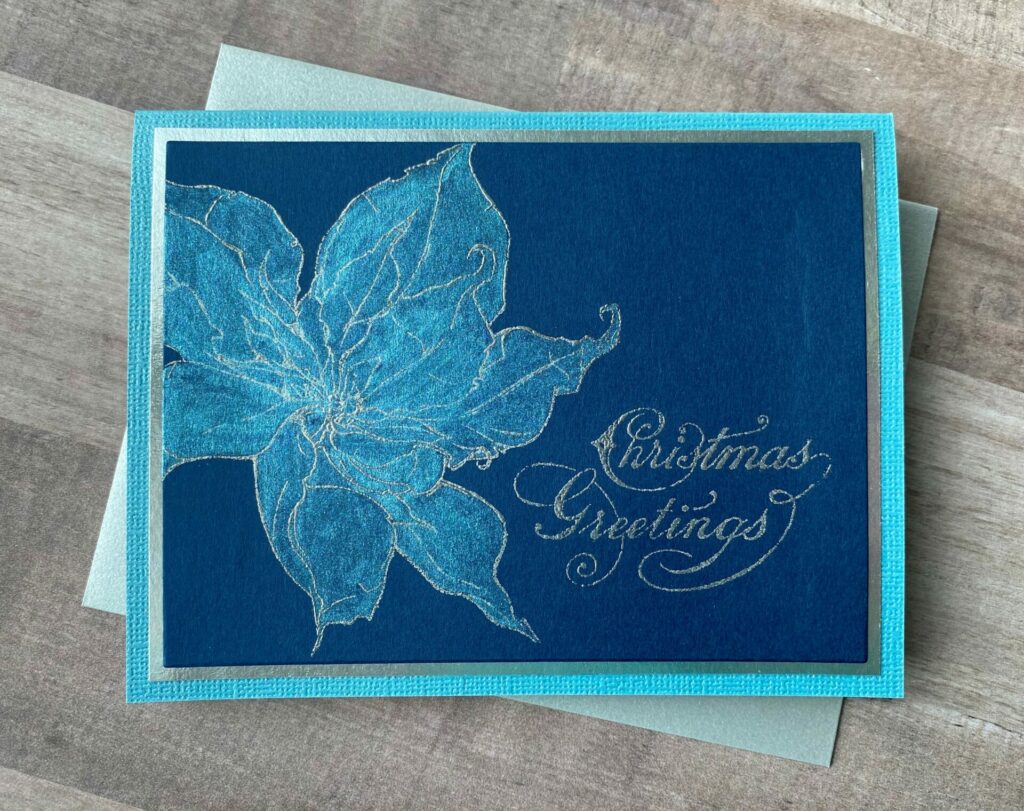 Blue poinsettia Christmas greetings card