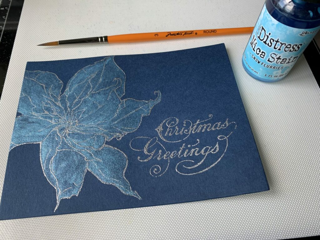 Poinsettia Christmas greetings card colored with distress mica stain in the shade snow flurries 