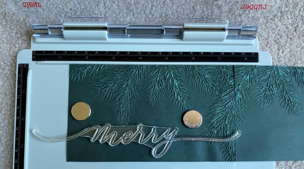 Embossing The Merry Sentiment