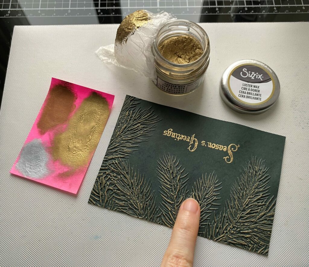 Applying the luster wax to the pine season's greetings card front