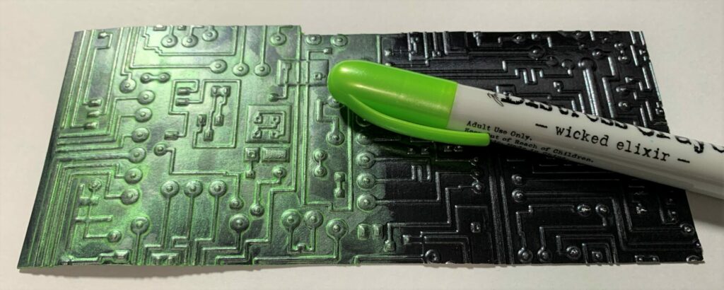 Applying green crayon to the 3D embossed circuit