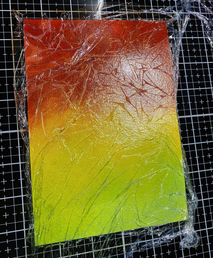 Crackle inked panel with plastic wrap on glass mat