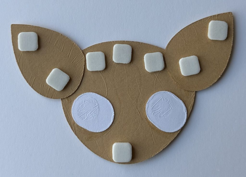 Add foam squares to the back of the dog head