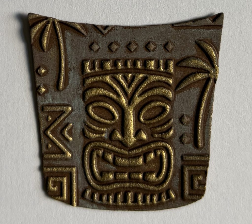 embossed tiki face