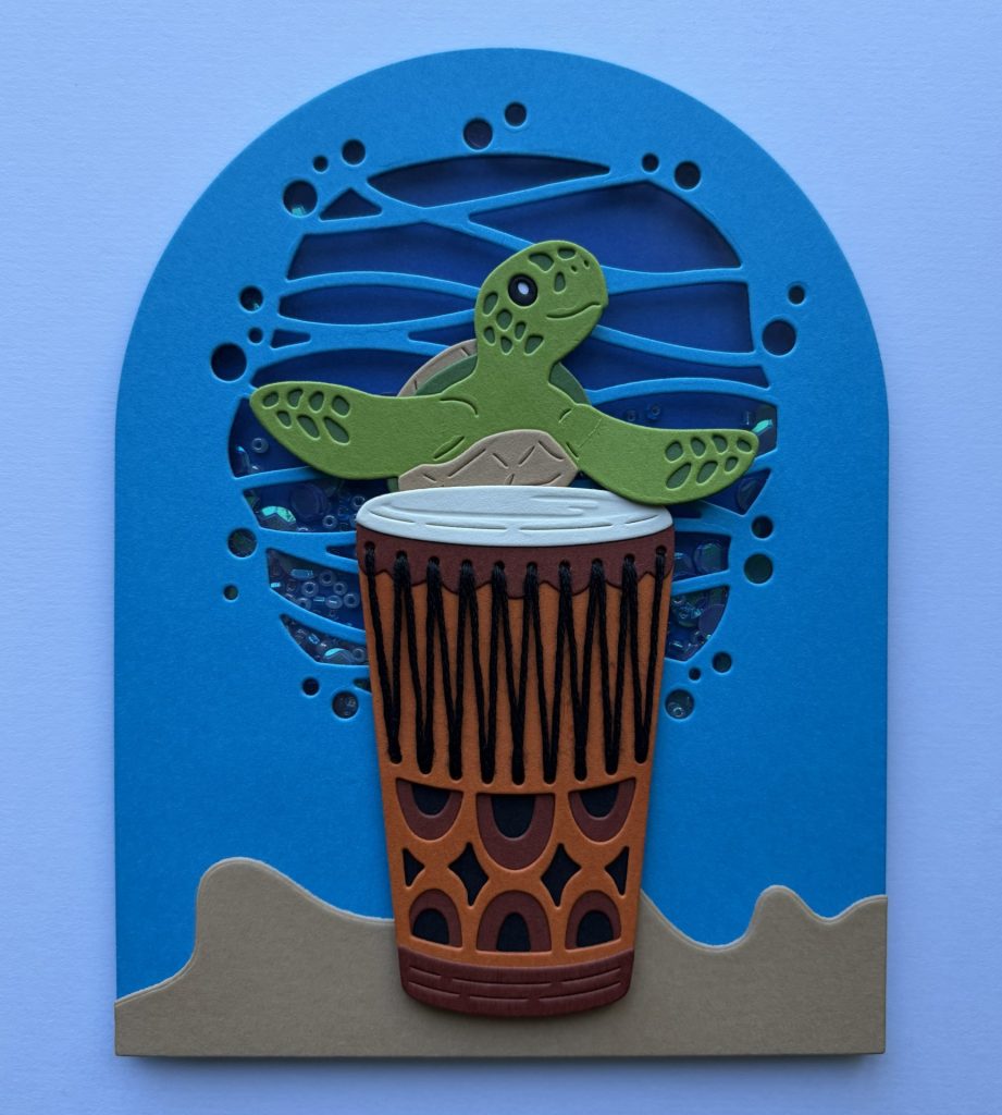 Add the sea turtle and drum to shaker card front